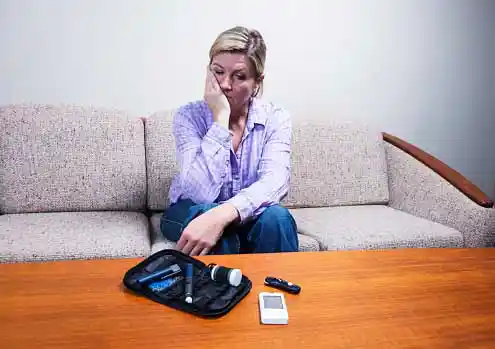 sad woman looking at medicine-device kit
